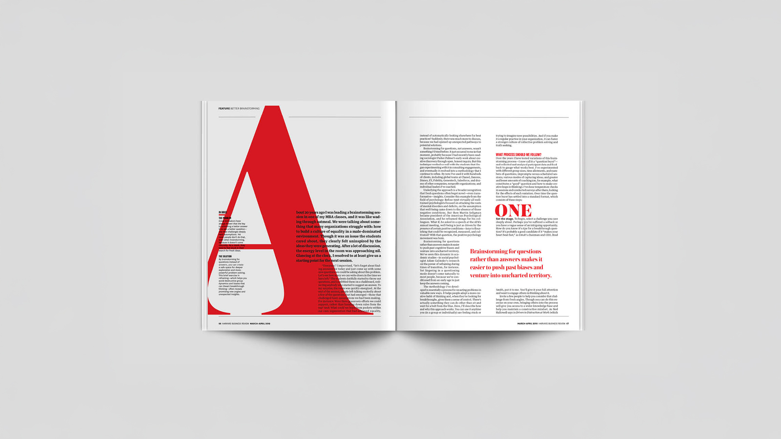 An image of a magazine opened to a spread. Left hand side has a large red A with typogrpahy. right hand side has typography Made in Adobe Indesign