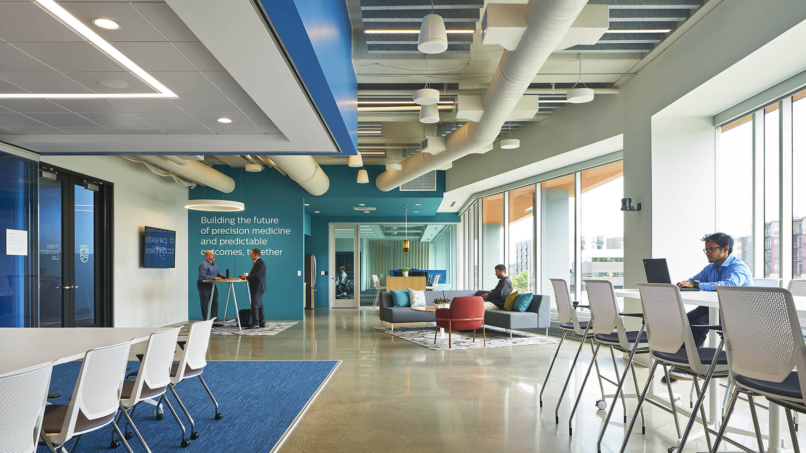A photograph of office space with color walls and typography